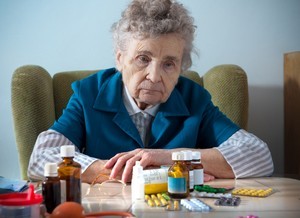 Senior-Elderly-Woman-Drugs-Prescription-Pills-Sad.jpg